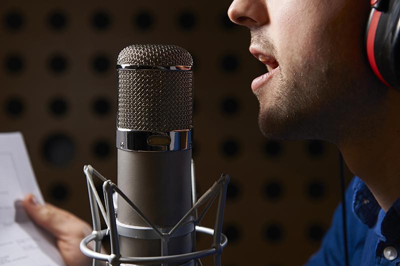 Man recording a voiceover in studio