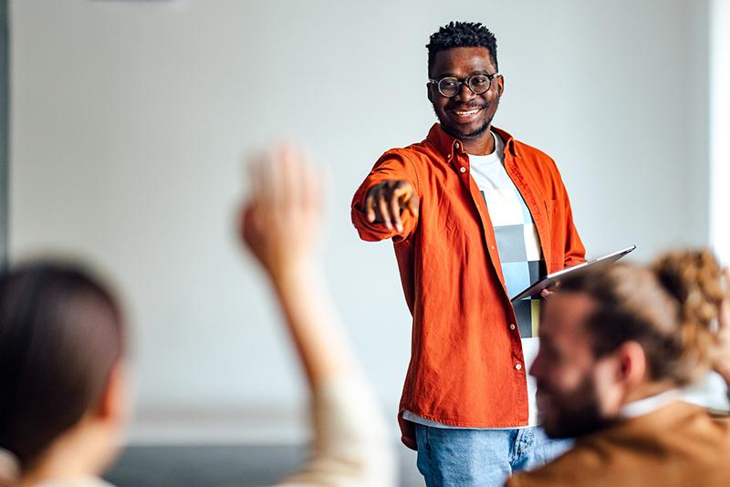 Black university teacher calling on a student in class