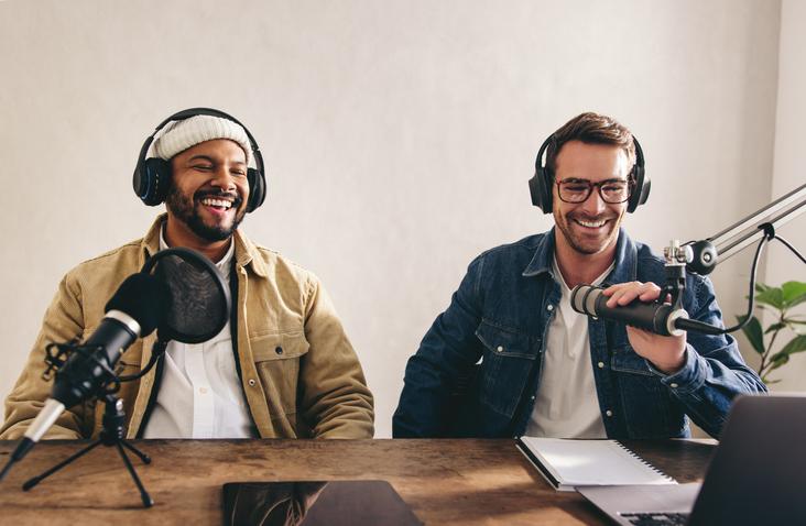 Two students have fun recording a podcast