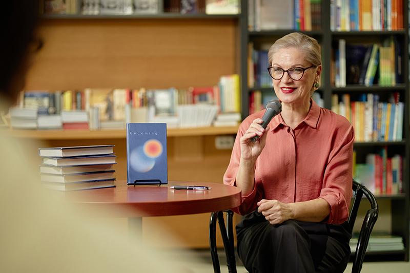 Female author doing a reading in a bookshop