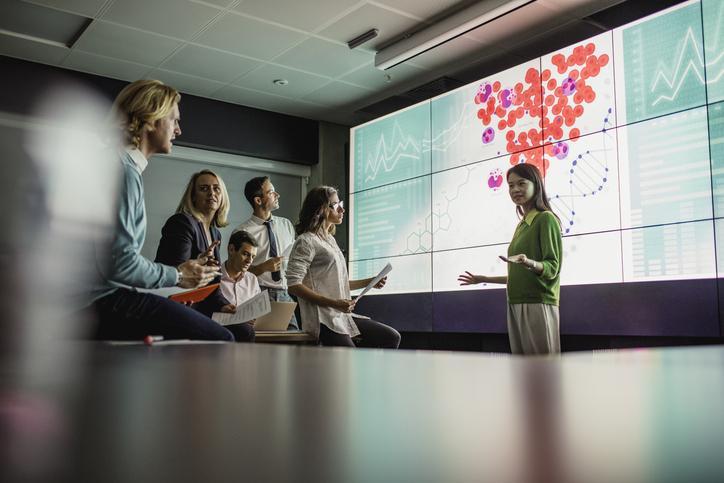 A scientist presenting research to an audience