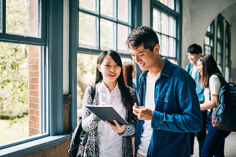 Asian students in light-filled university building