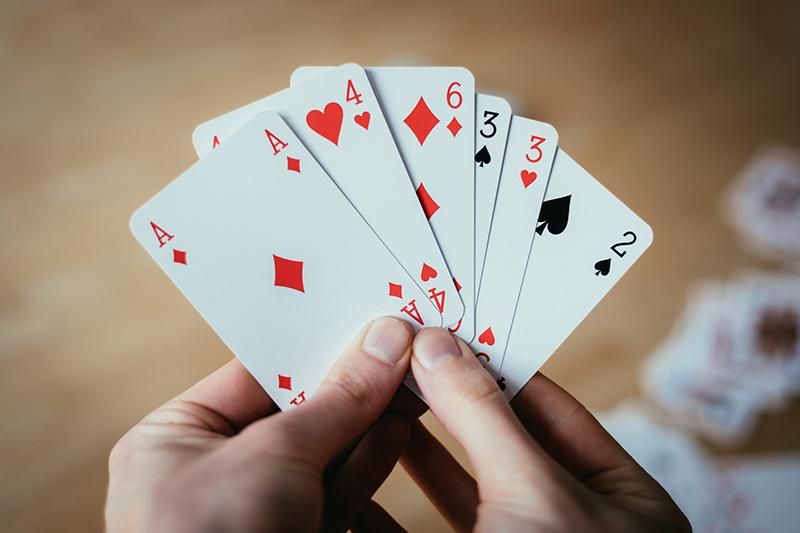 Woman's hands holding playing cards