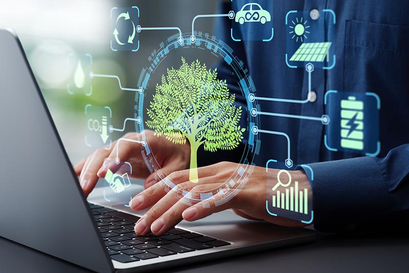 Man typing at laptop with sustainability symbols surrounding it
