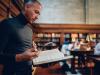 A male academic studying in a university library