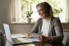 A middle aged woman working at a laptop