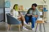 Two women in a classroom talking