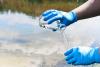 Detail of hands collecting river water