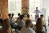 Male speaker giving presentation at a university to a room full of students