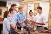 A tutor talks to apprenticeships in a carpentry workshop