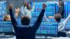 Traders at their computers celebrating