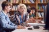 Female college professor helping male student