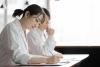 Young female Asian university student in white coat