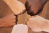 Multiracial hands in fist bump circle