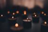 Lit candles in a darkened room
