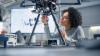 A Black woman engineer building a robot
