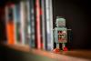 A toy robot stands on a shelf