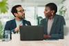Two scholars discussing over laptop