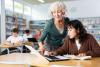 An educator helps a student in class