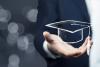 Hand holding mortar board, digital credentials