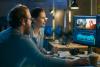 Man and woman working on film editing