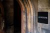 A doorway with an "admissions" sign next to it