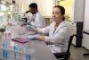 Female scientific researcher in wheelchair in lab