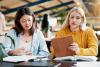 Female college students working together in class
