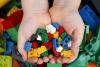 Child's hands holding Lego bricks