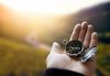 A hand holds a compass