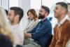 Academics watching an unseen speaker