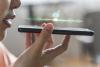 Woman talking into smartphone, AI as student support