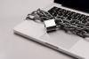 A laptop with a padlocked chain around it