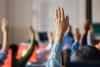 Students raising hands in class