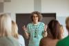 A teacher presenting to a class full of students