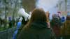 A young woman holds a megaphone at a protest