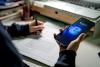 A student uses an AI tool on their phone while working