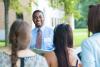 Tour guide showing potential students around university campus