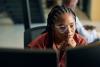 Black female professional working at computer