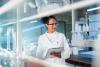 Latino female researcher taking notes in a laboratory