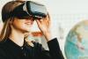Young woman wearing virtual reality headset with globe in background