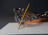 A mechanical robot hand writes on a notepad