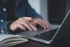 Female student writing on laptop