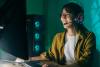 Young Asian woman gaming with headset on